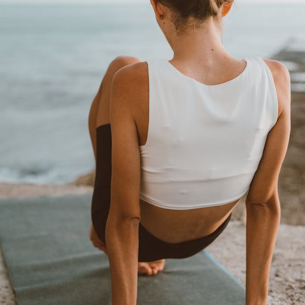 Person stretching peacefully outdoors, symbolizing well-being and flexibility.
